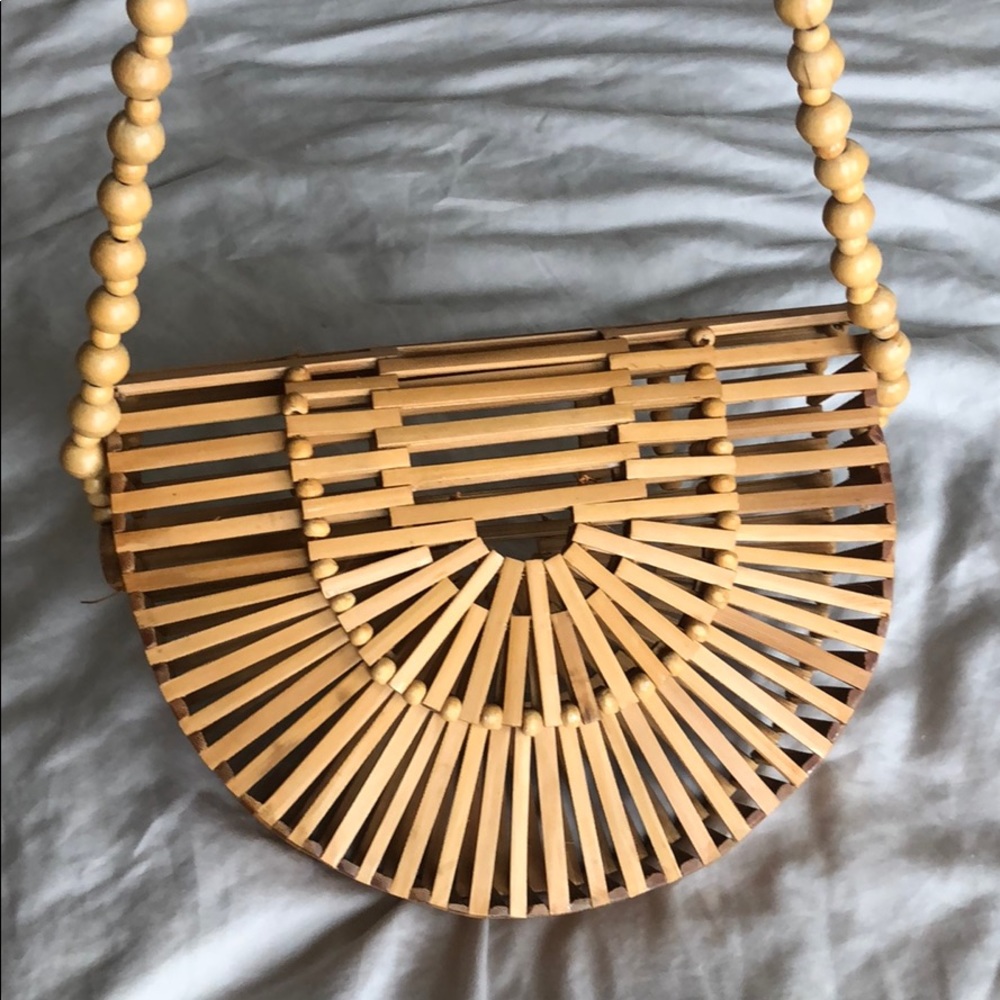 Wood handcrafted bag with beaded handle.